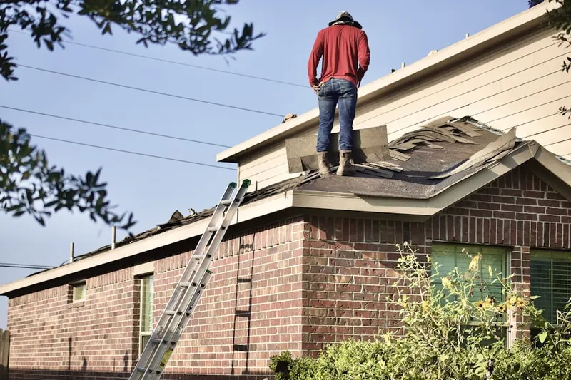 Professional roofer working on a residential roof in Rockport